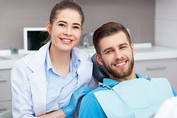 man smiling in dentist chair with female dentist, Albuquerque, NM cosmetic dentistry